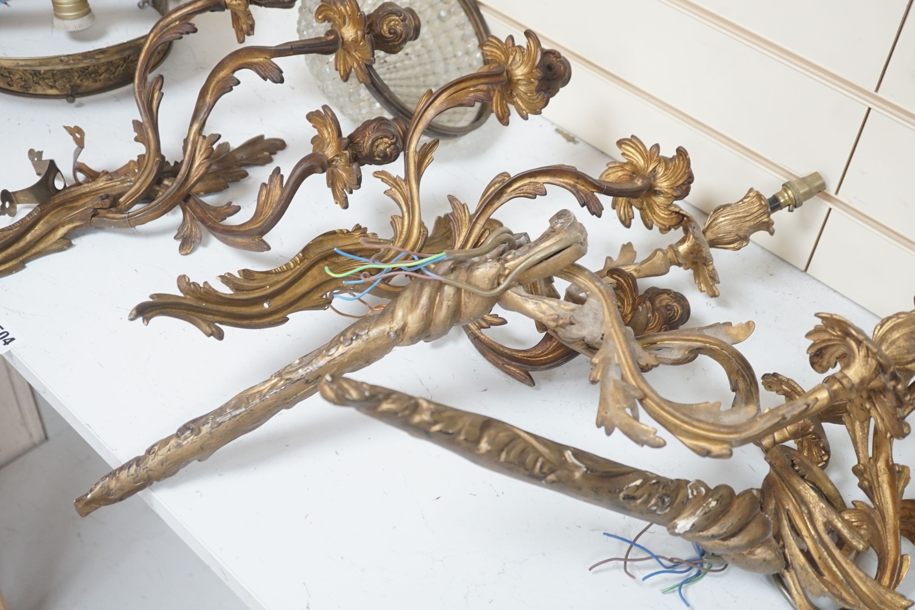 A pair of gilt metal 3 branch wall sconces, a pair of gilt plaster ditto and other light fittings